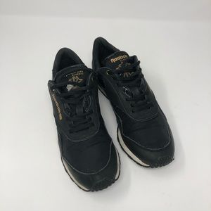 Reebok black and gold athletic shoe